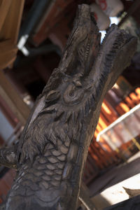 Low angle view of owl perching on statue