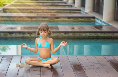 Girl meditating with eyes closed