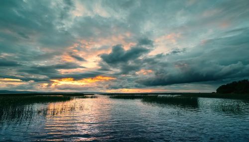 Scenic view of lake against sky during sunset