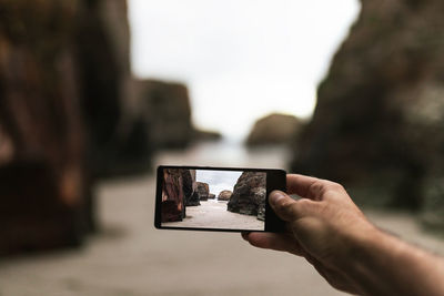 Midsection of person holding smart phone