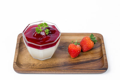 Close-up of strawberries on table against white background