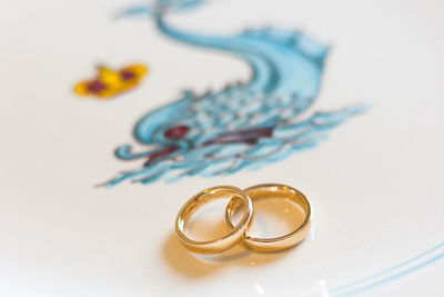 Close-up of padlocks on table against white background
