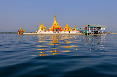 View of building by sea against sky