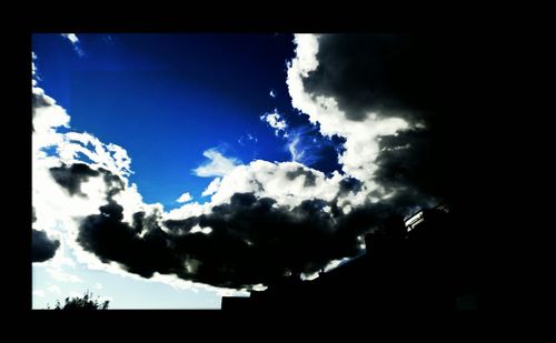 Silhouette trees against blue sky