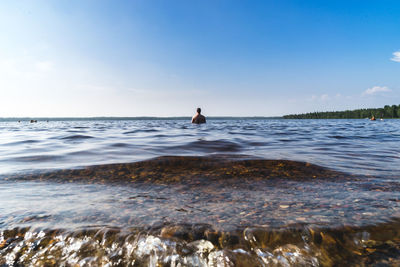 Rear view of man in sea