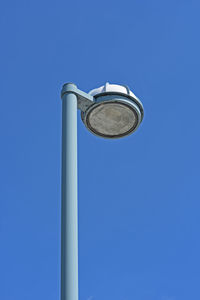 Low angle view of street light against clear blue sky