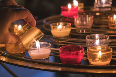 Close-up of illuminated tea light candles on table