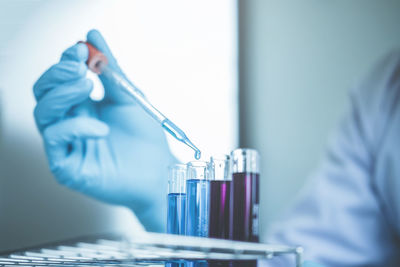 Close-up of scientist doing experiment at laboratory