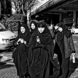 Portrait of people walking in city