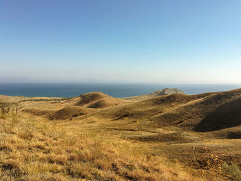 Scenic view of landscape against clear blue sky
