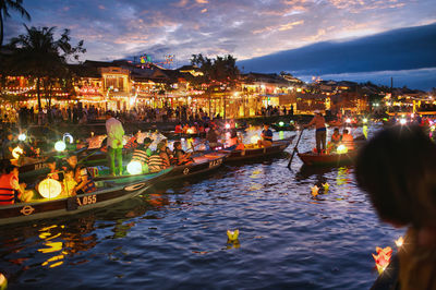 High angle view of people in sea against sky at night