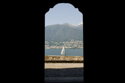 View of sea and mountain seen through arch