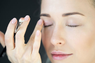 Close-up portrait of woman with hands