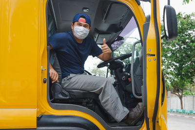 Portrait of man sitting in bus