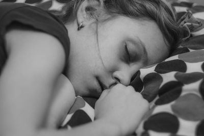 Close-up of baby sleeping on bed