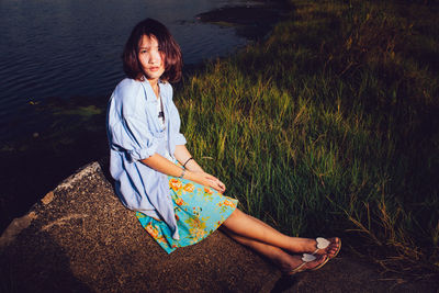 Portrait of woman sitting on field