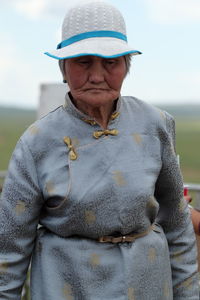 Portrait of senior man standing against sky