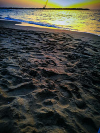 Scenic view of beach against sky during sunset