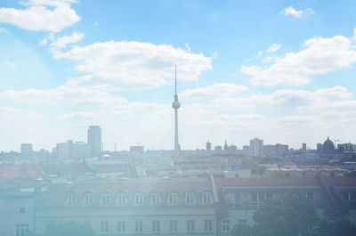 View of cityscape against cloudy sky