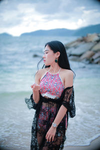 Young woman standing at beach