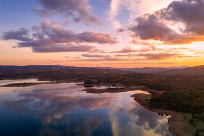 Drone aerial view of a lake reservoir of a dam with reflection on the water in sabugal, portugal