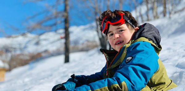 Portrait of boy in warm clothing on snow