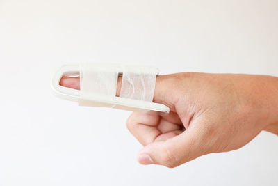 Close-up of human hand against white background