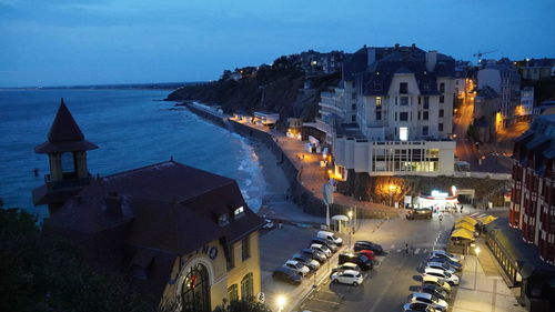 High angle view of townscape by sea against sky