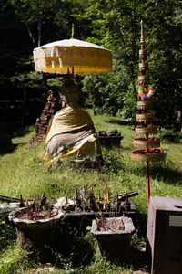 Sculpture in yard against temple