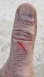 Close-up of human hand against blurred background