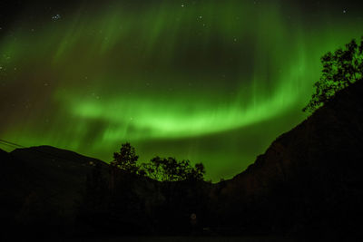 Scenic view of landscape against sky at night