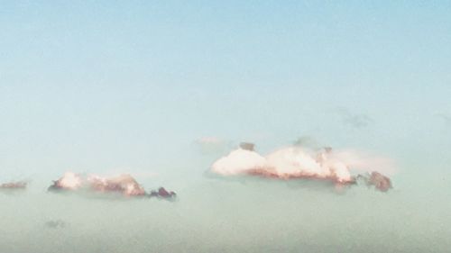 Smoke emitting from volcanic on field against sky