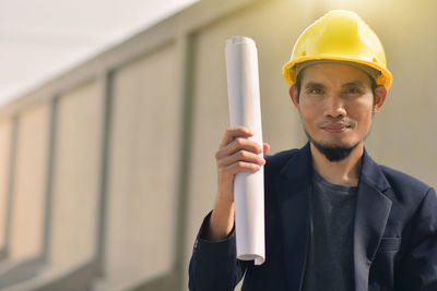 Portrait of smiling man holding hat