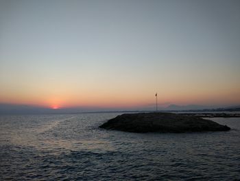 Scenic view of sea against clear sky during sunset