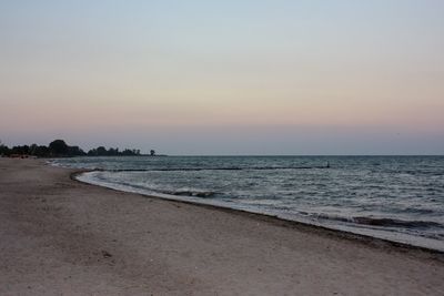 Scenic view of beach against sky during sunset