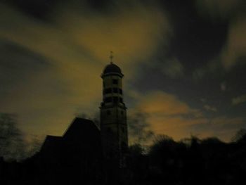 Low angle view of tower against cloudy sky