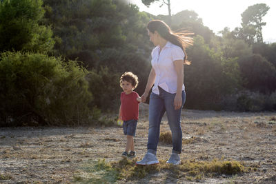 Woman with her son walking and enjoying the countryside far from the city