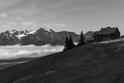 Houses on mountain against sky