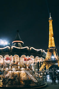 Illuminated ferris wheel at night