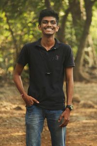 Portrait of smiling young man standing on land