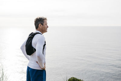 Man looking at sea against sky