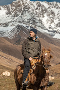 Rear view of man riding horse