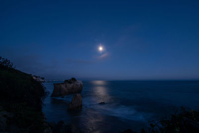 Scenic view of sea against sky at night