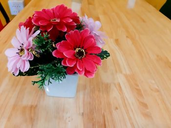 High angle view of pink flower on table