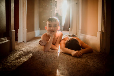 Portrait of boys relaxing on floor at home