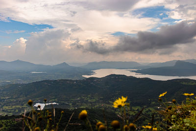 Scenic view of sea and mountains against sky