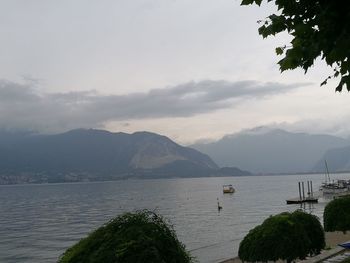 Scenic view of sea and mountains against sky