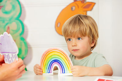 Portrait of cute girl playing with toys