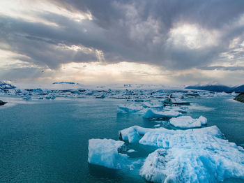 Scenic view of icebergs in jokulsarlon glacier lagoon, iceland, at dusk.