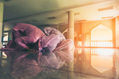 Midsection of man sitting in building